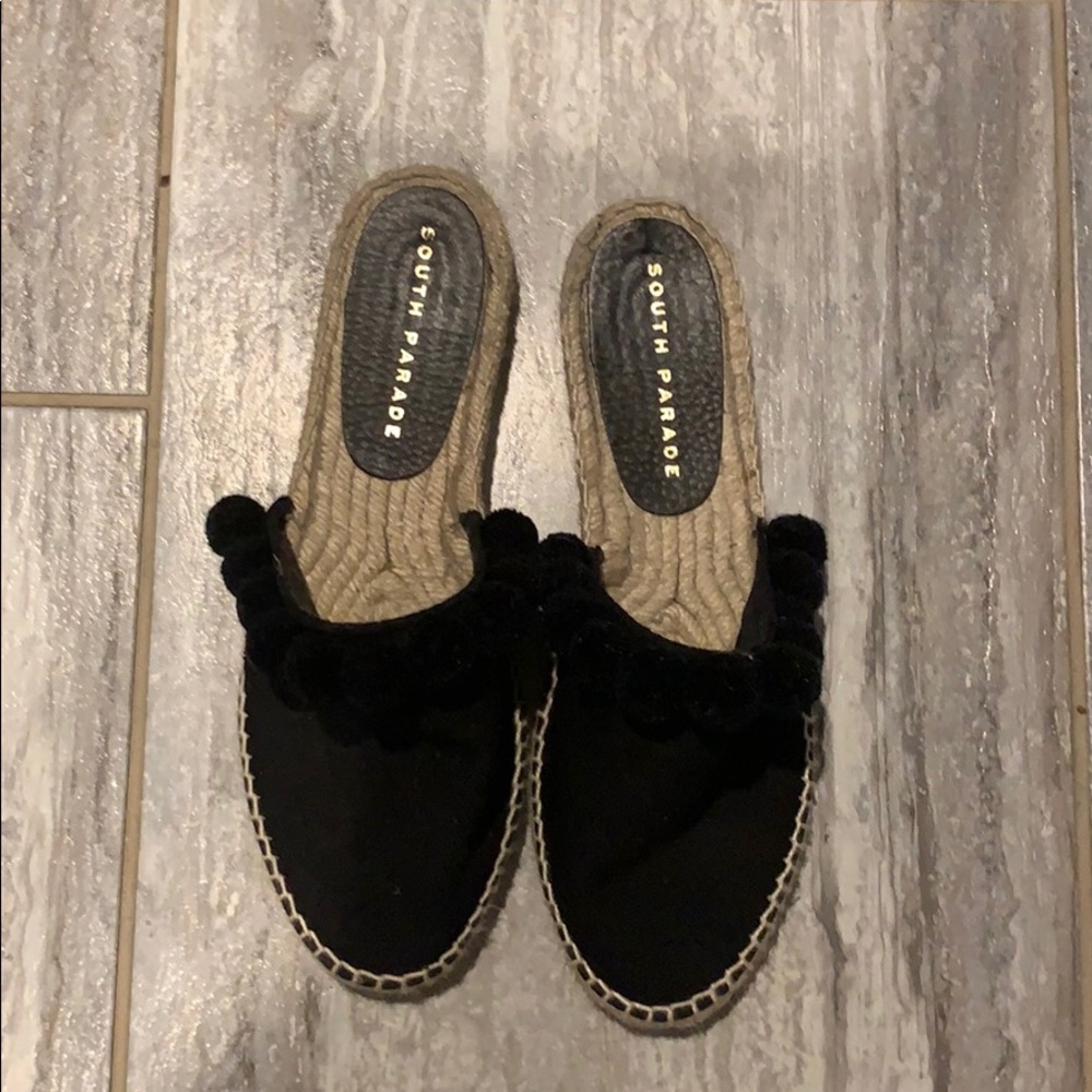Black flats with pom poms